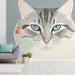 Cozy entryway with a playful cat mural above a comfortable armchair