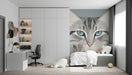Modern nursery room with a gray cat portrait wall mural behind a white crib