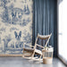 A classic powder room featuring blue French Bulldog toile wallpaper with antique brass fixtures.