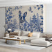 A sophisticated living room with a blue and white chinoiserie mural wall behind a dark wood table.