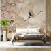 Crane and cherry blossom wallpaper installed behind a neutral bed frame in a master bedroom