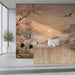 A tranquil dining room wall covered in a sunrise crane landscape mural with soft ambient lighting.