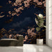 Entryway wall mural featuring cranes and cherry blossoms behind a velvet sofa
