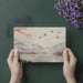 A peaceful home office space adorned with a soft-toned cherry blossom and flying crane landscape wallpaper.