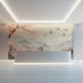 A tranquil reception wall featuring a cherry blossom and crane landscape mural behind a minimalist bed frame.