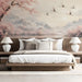 A sunlit bedroom featuring a delicate crane and floral mountain scene mural on the main accent wall.