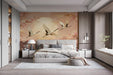 Bedroom interior with a large crane and cherry blossom mural behind a contemporary grey sofa
