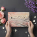 Serene Japanese crane mural wallpaper in a bedroom behind a simple wood bed frame