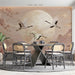 A calming dining room wall featuring a crane and cherry blossom mural above a soft cream upholstered headboard.