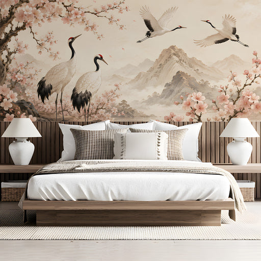 A bedroom wall with a serene mural of flying cranes and pale pink flowers