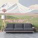 Minimalist mountain meadow mural installed on a long cinema room wall above a beige sofa