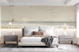 Minimalist coastal wall mural installed behind a neutral fabric sofa in a bedroom