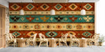 A cozy bar featuring the southwestern eagle mural behind a leather sofa and wooden coffee table.