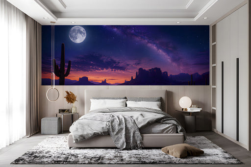 A cozy bedroom with a dark desert night sky mural behind the bedframe.