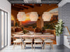 A warm sunset canyon mural installed in a rustic dining room with leather furniture.