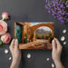 A rustic dining room with the southwest landscape mural behind a wooden table.