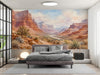 A cozy bedroom featuring a desert landscape wall mural behind a mid-century modern sofa.