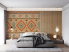 Modern bedroom with a Southwestern geometric wallpaper feature wall and leather sofa