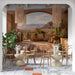 A cafe featuring the desert adobe mural as a backdrop for a neutral linen sofa and woven decor.
