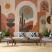 Cozy living room featuring a desert landscape wallpaper with archway designs and potted plants.