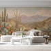 A relaxed commercial room space decorated with warm southwestern landscape mural wallpaper.