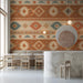 Cafe wall featuring a horizontal tribal geometric mural in warm earthy tones with a tan leather sofa