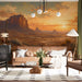 A living room styled with the desert sunset mural, paired with warm wooden furniture and organic decor.