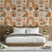 Earthy geometric wallpaper featuring terracotta suns in a modern bedroom space