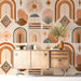 Bohemian sun mural wallpaper installed in a cozy sun-drenched bedroom with woven furniture