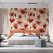 A bright, elegant bedroom decorated with large-scale magnolia blossom wallpaper and a classic side table.