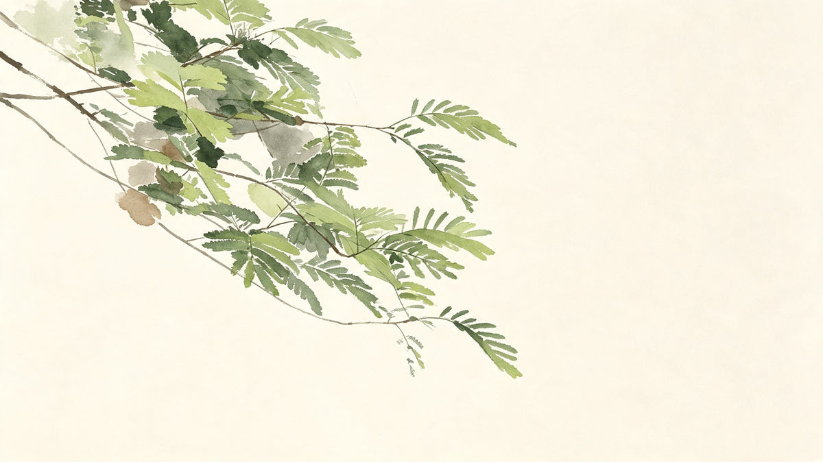 A watercolor illustration of a delicate green fern branch on a soft cream background.