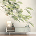 The fern branch mural installed as a calming focal point in a bright, modern bedroom.