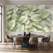 Soft green watercolor leaf mural installed in a bright office with wooden furniture