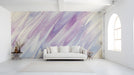 Soft lavender watercolor mural installed behind a minimalist bed in an entryway