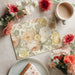 Vintage garden rose wallpaper as a feature wall in a sunlit breakfast nook