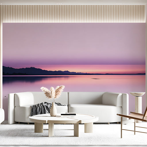 Soft gradient pink wall mural behind a lounge chair in a living room