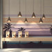Coastal style shop with a sunset palm beach wall mural and light wooden furniture.