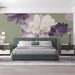 Floral mural installed on a bedroom wall behind a light wood bed frame