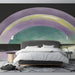 Contemporary bedroom space with a soothing watercolor arch mural above a low platform bed