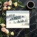 A minimalist home office featuring a foggy forest wall mural as a calm backdrop.