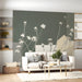 Botanical art mural behind a reading chair in a bright, airy living room nook.