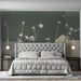 Floral wall mural in a minimalist bedroom with neutral bedding and wooden side tables.