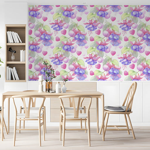 A feminine dining room with a floral and heart wallpaper mural featuring pink fuchsia blooms and soft green leaves