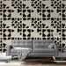 Sleek living room design featuring a bold abstract geometric feature wall in a monochromatic neutral palette.
