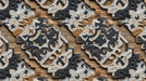 Repeating pattern of 3D architectural relief featuring charcoal and sandstone stone carvings