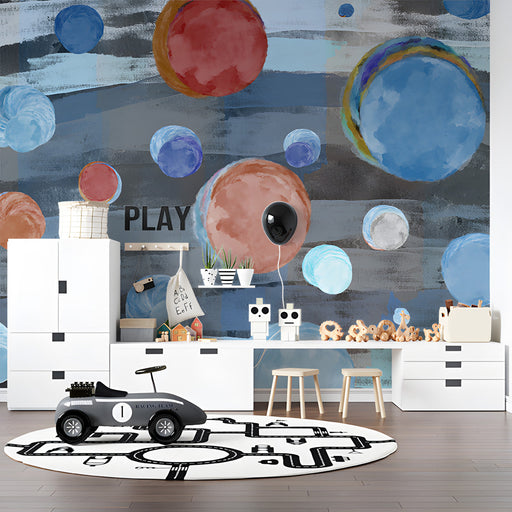 Contemporary playroom wall showcasing artistic circular mural patterns behind a velvet navy sofa