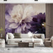 A quiet living room styled with large-scale artistic floral wallpaper and a mid-century modern lounge chair.