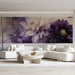 Moody floral mural wallpaper installed as a dramatic feature wall in a living room with velvet bedding.