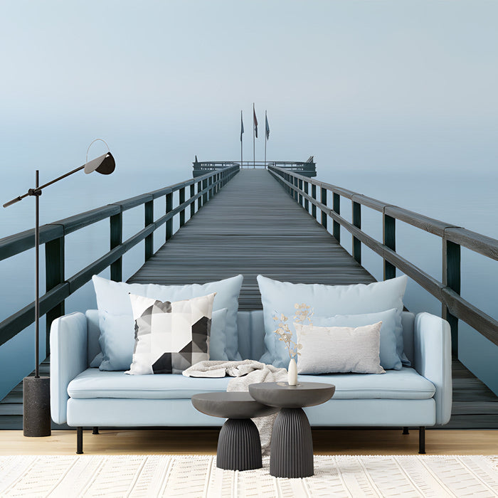 A modern living room featuring a serene misty pier wall mural behind a low profile grey sofa.