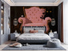 Whimsical armchair mural installed in a moody bedroom with dark wood furniture